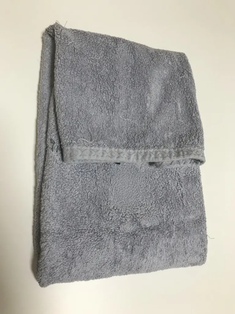 Wrapping an ice pack in a towel for safe rabbit cooling