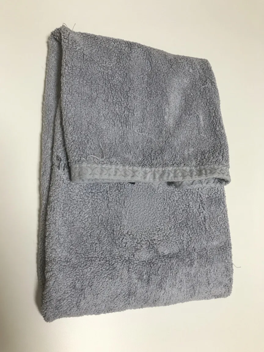 A gray towel used to wrap the cooling mat and ice pack for a rabbit