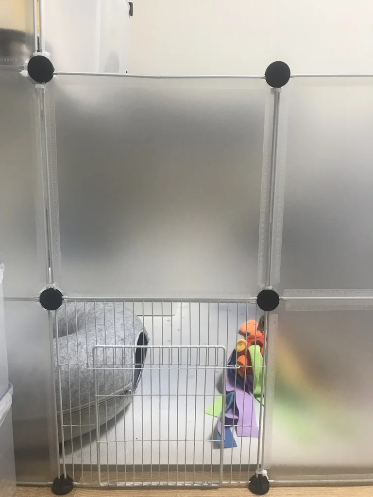 Fully metal mesh door panel connected to opaque plastic panels of a DIY rabbit enclosure