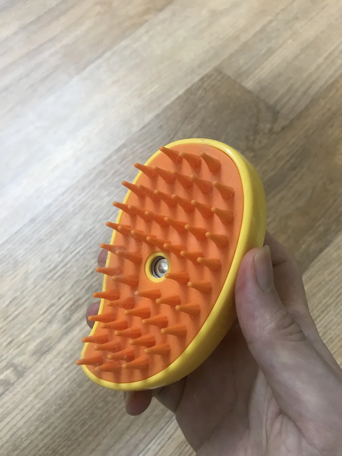 Silicone steam brush with loose rabbit fur caught on the cones, steam off