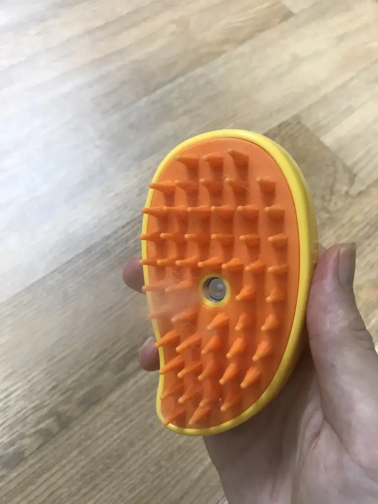 Steam brush misting water onto rabbit fur