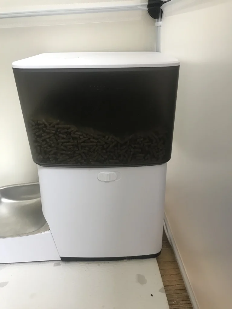 Automatic pellet feeder with a stainless steel bowl that the rabbit flings when it is empty